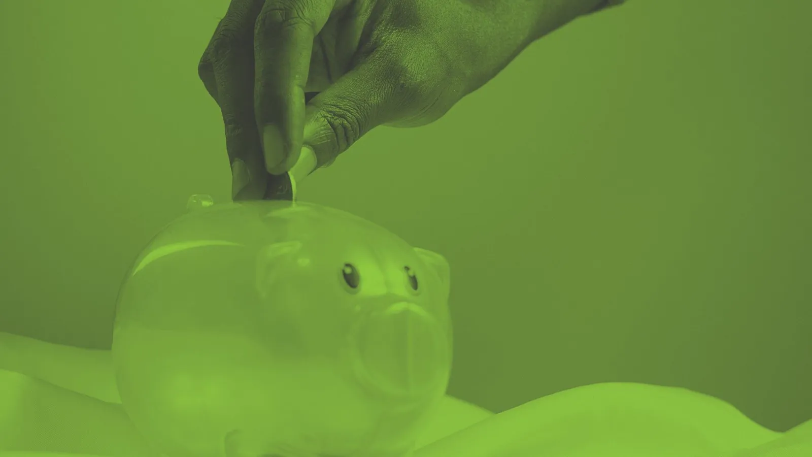An image of a child putting money into a piggy bank - provision of programmes to improve financial literacy and education